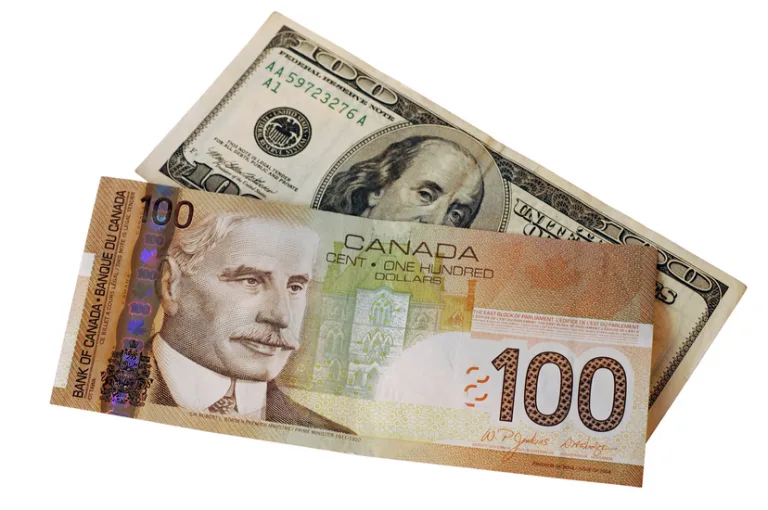 USD paper money under a CAD paper money