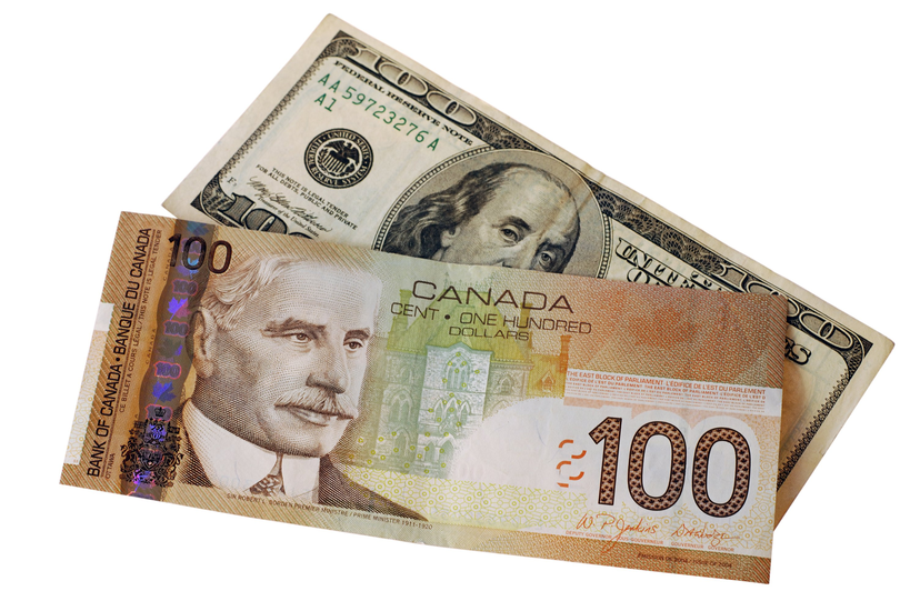USD paper money under a CAD paper money