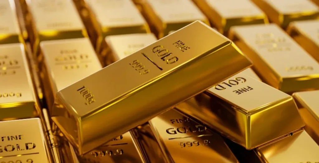 The image shows stacked gold bars with FINE GOLD engraved